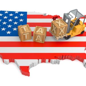 the united states of america with the flag covering the country. block letters spell out tax and a construction vehicle is picking up the block letters