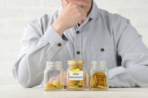 Man Looking At Jars of Coins