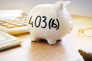 Piggy bank with sign 403b on a side. 