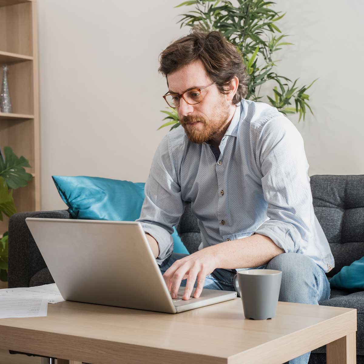 Male businessman working on laptop from home