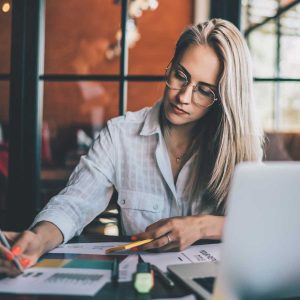Young focused woman working with chart 