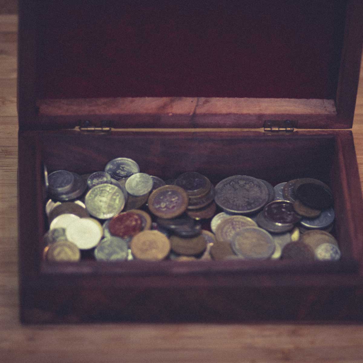 Vintage wooden vintage retro jewelry box with metal coins from different countries