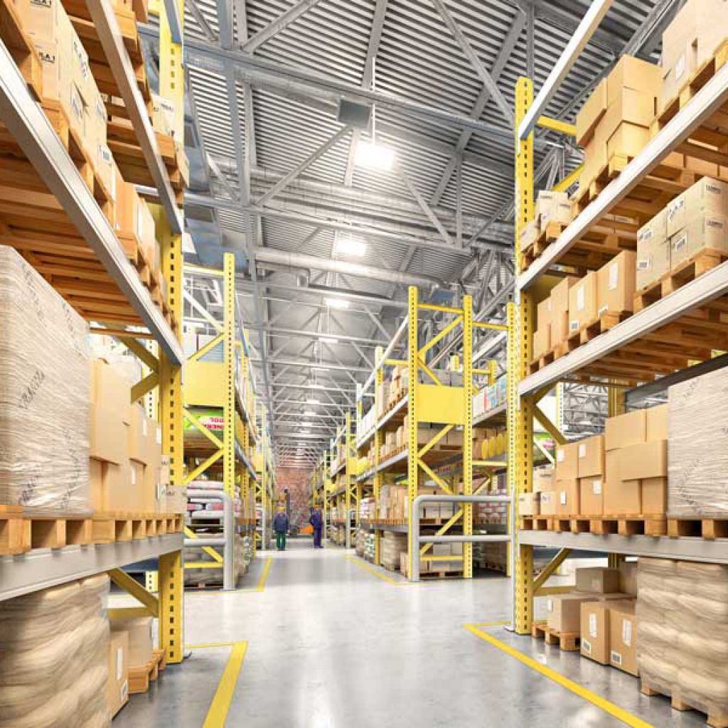 empty manufacturing warehouse with boxes and equipment stored along the walls