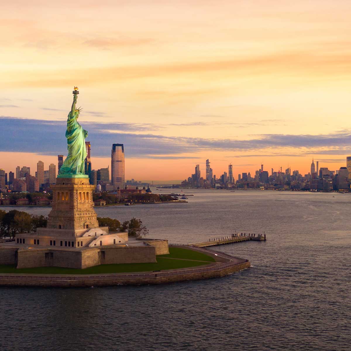 Liberty statue in New York city at sunset
