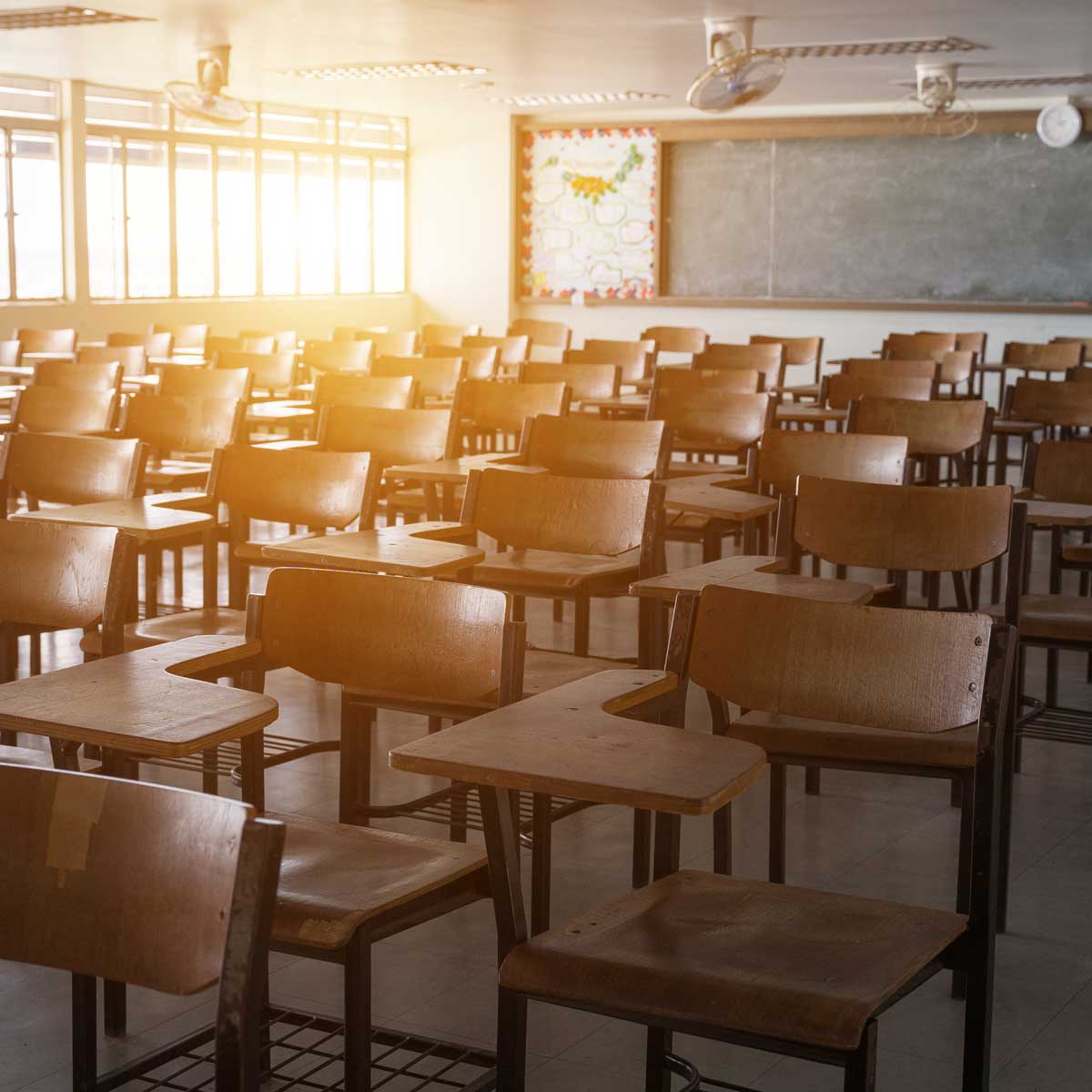 Empty classroom with vintage tone wooden chairs. school concept.