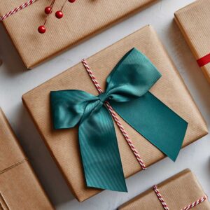 Holiday presents wrapped in brown paper and decorated with bows and ribbons. Image taken from above