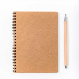 Brown spiral notebook isolated on white background. top view