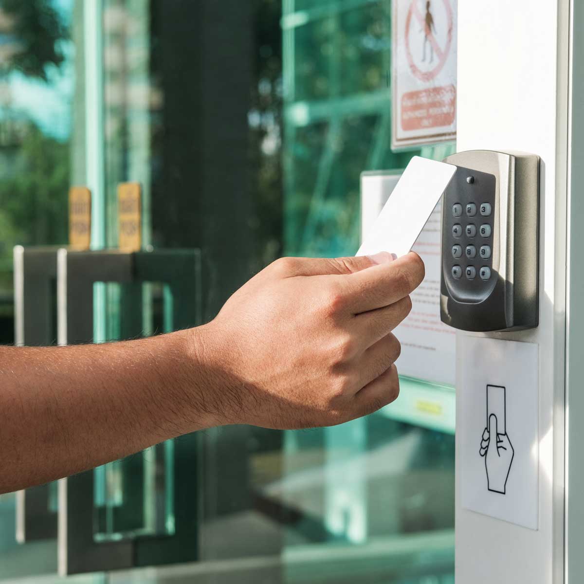 Hand-using-security-key-card-scanning-to-open-the-door-to-entering-private-building.-Home-and-building-security-system