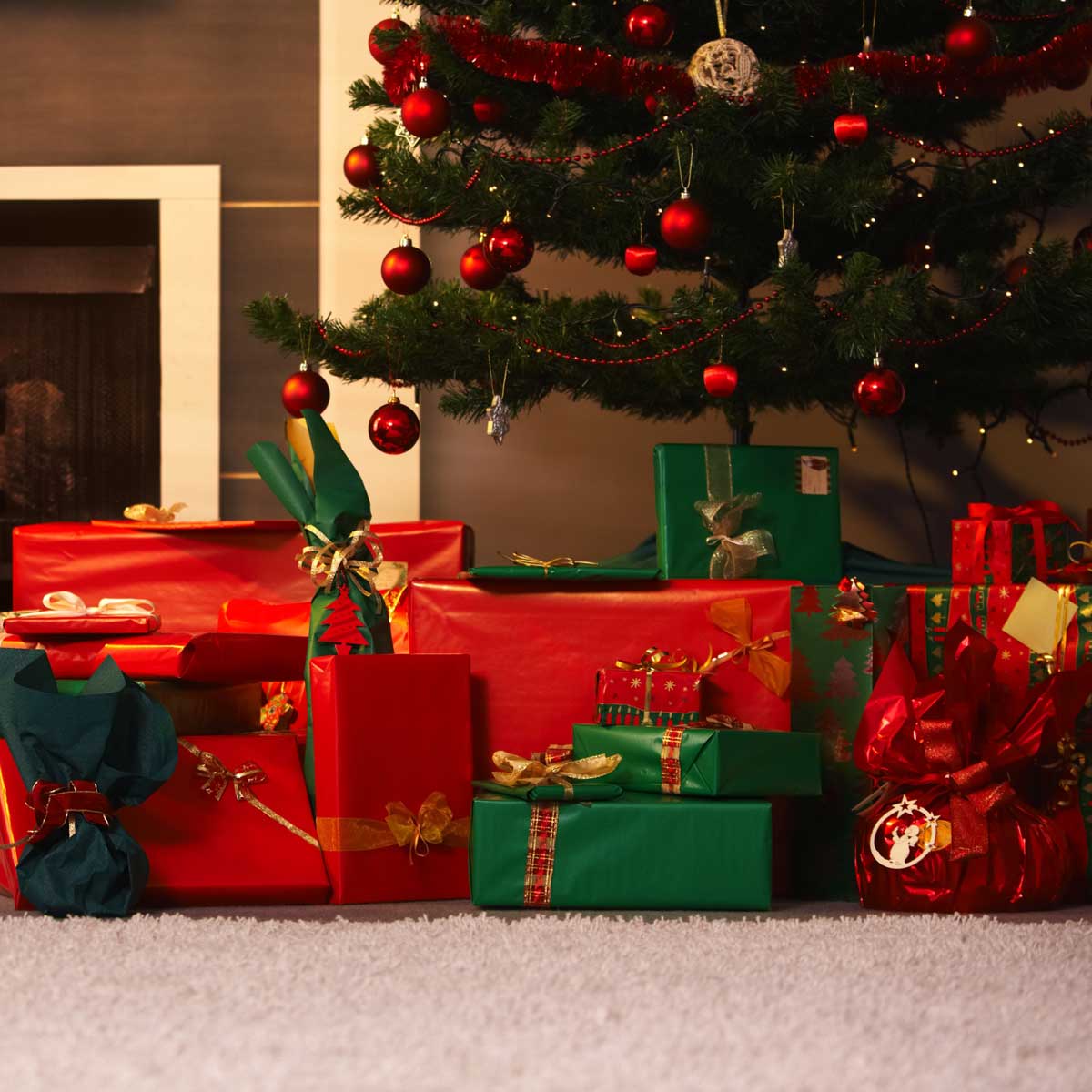red and green wrapped presents under Christmas tree