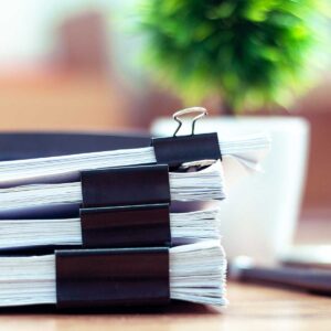 Stack-of-documents-placed-on-a-desk-in-a-business-office