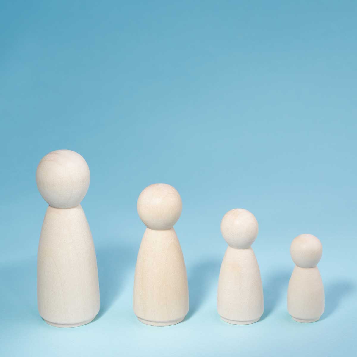 Wooden figurines standing in a row from high to low. Concept person growth on blue background. Management strategy. Leadership concept. Teamwork idea.