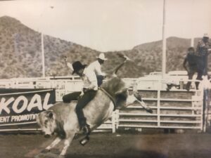 Sikich CEO Chris Geier riding a bull at the Arizona rodeo.