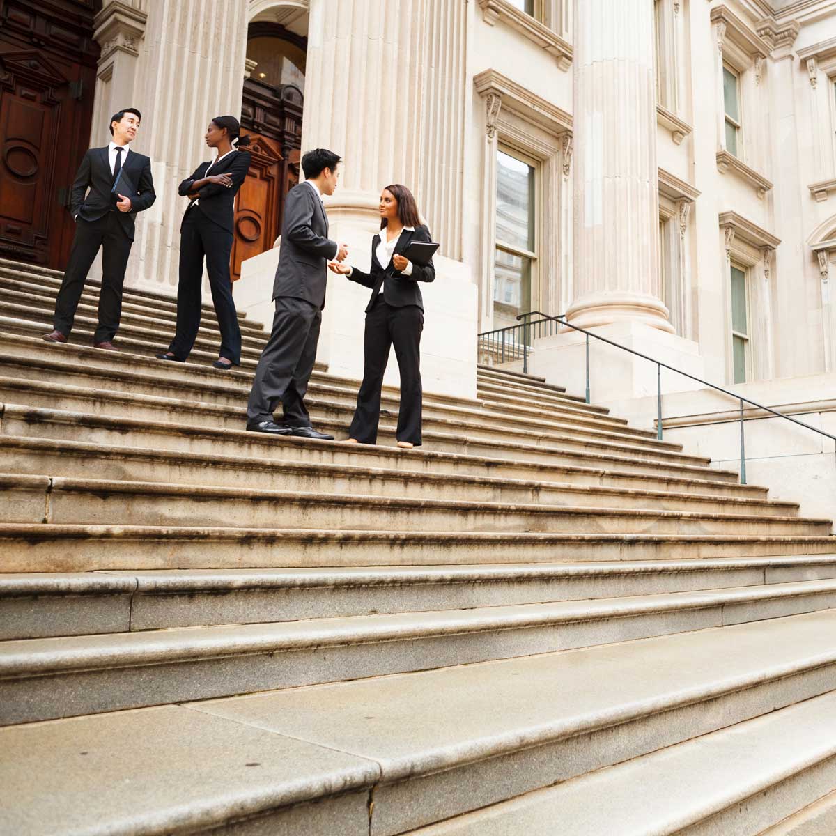 government-professionals-in-discussion-on-the-exterior-steps-of-a-U.S.-government-building